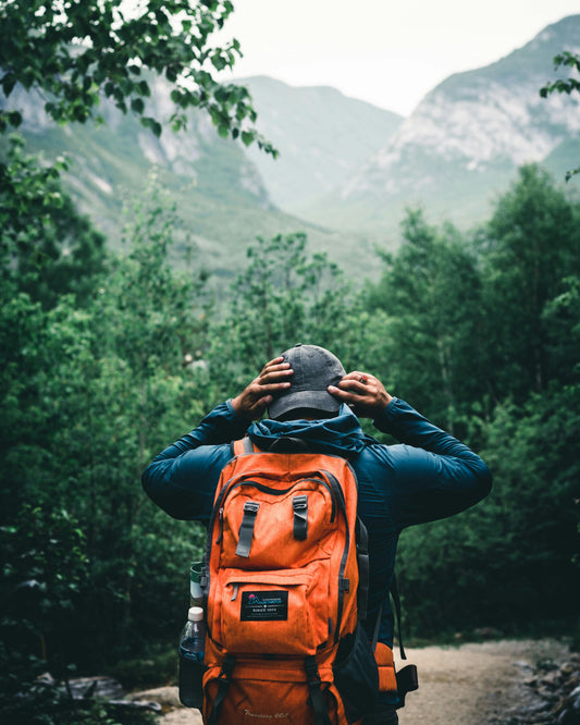 orange travel bag for hiking in wilderness and mountains